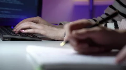 Two individuals exchange feedback and write notes during dynamic development Stock Photos