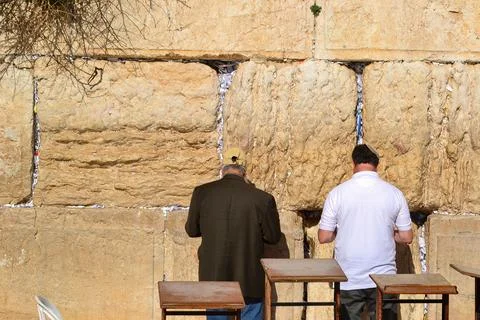Two individuals in Reflection at the Western Wall in Jerusalem, Israel Stock Photos