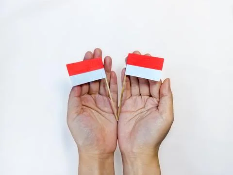 Two Indonesian Flags on Hands Foto stock