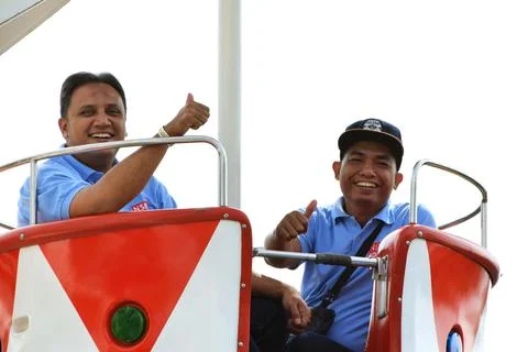 Two Indonesian men are using the Carousel at the Batu Love Garden Stock Photos