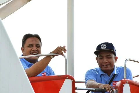 Two Indonesian men are using the Carousel at the Batu Love Garden Stock Photos