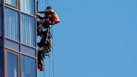 Two industrial climbers work on the building, repair the windows Stock Footage 147455754
