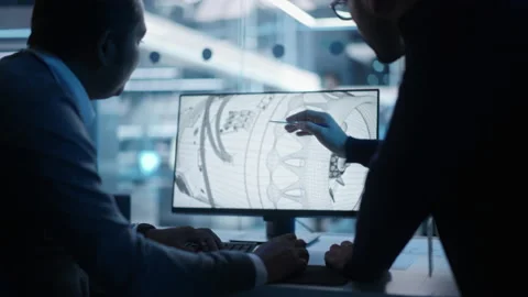 Two Industrial Developers Working on Computer Video stock 229841651