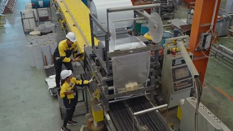 Two industrial engineer inspecting the machine in metal factory working at plant Stock-Footage 242106111