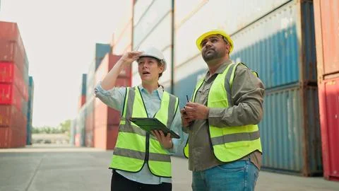 Two industrial engineer using tablet working together at the container warehouse 스톡 사진