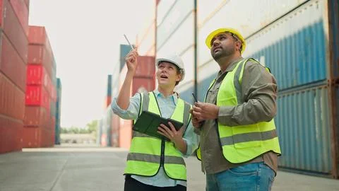 Two industrial engineer using tablet working together at the container warehouse 스톡 사진