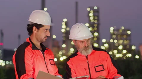 Two industrial engineers collaborating on site management data Stock Footage 333589380