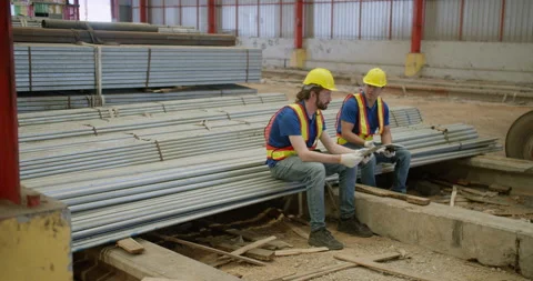 Two industrial workers collaborate while inspecting inventory data on a digital Stock Footage 333638868