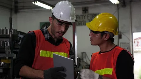 Two industrial workers using digital tablet, discussing work Stock Footage 170420661