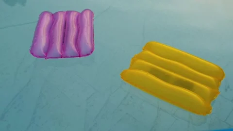 Two inflatable pillows lie on the surface of the water in the pool Stock Footage 244334152