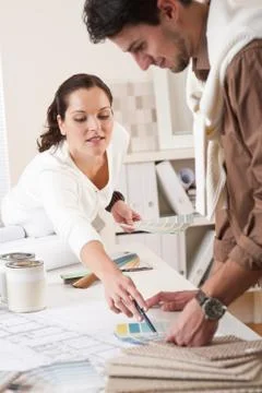 Two interior designer working at office with color swatch Fotos Stock
