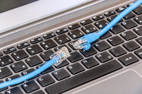 Two internet cable on computer keyboard Stock Photos