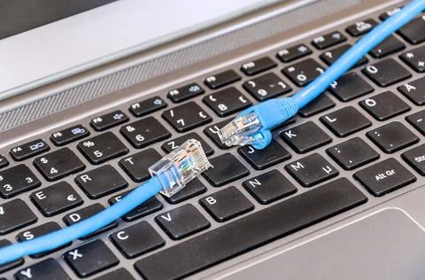 Two internet cable on computer keyboard Two internet cable on computer key... Stock Photos