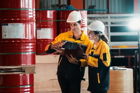 Two inventory inspector conduct inspection on chemical barrel. Exemplifying Stock Photos
