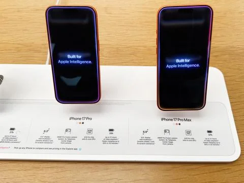 Two iPhone 17 Pro Max models on display stand showcasing Apple Intelligence.. Stock Photos