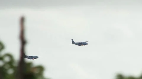 Two Irish Air Corps Casa transport planes flyby over Dublin behind treetops Stock Footage 32396012