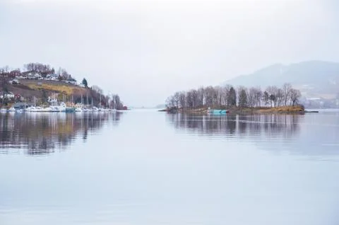 Two islands on norway lake with houses trees and boats. Original wallpaper fr Stock Photos