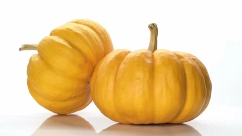 Two isolated orange pumpkins rotating on the white background with copy space Stock Footage 162846774