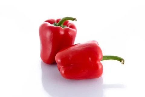 Two isolated red peppers Stock Photos