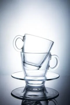 Two isolated transparent tea cups with saucers Stock Photos