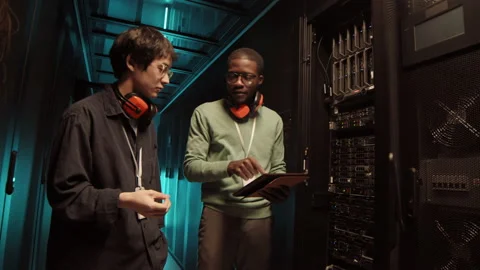 Two IT Engineers Having Conversation in Data Center 動画素材 149654804