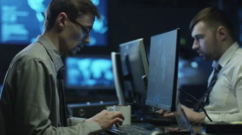 Two IT programmers are working on computers in a dark office room 스톡 동영상 59157479