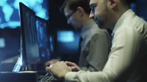 Two IT programmers are working on computer in a dark office room 스톡 동영상 59383038