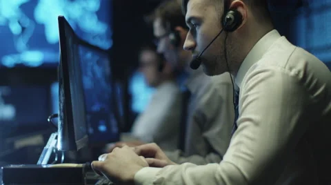 Two IT programmers are working on computer in headset in a dark office room Stock-Footage 59384198
