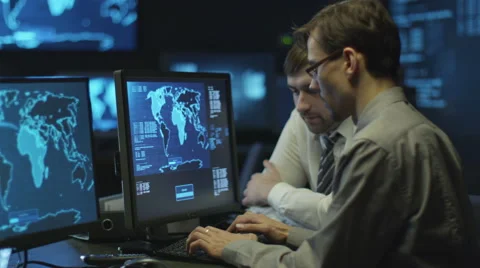 Two IT programmers are working on computer in a dark office room 스톡 동영상 59385508
