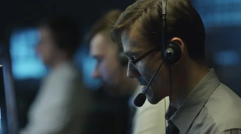 Two IT programmers are working on computer in headset in a dark office room 스톡 동영상 59385774