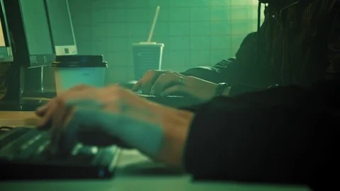 Two IT programmers are working on computer in a dark office room filled with Stock Footage 106351455