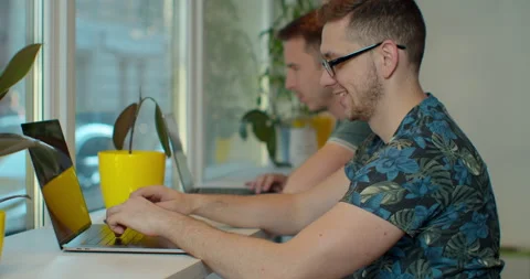 Two IT programmers are working on computer in a modern office room. Web Stock Footage 137173727