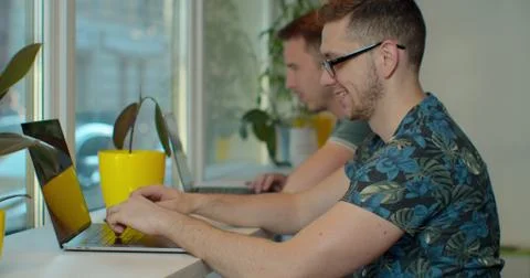 Two IT programmers are working on computer in a modern office room. Web Stockfoto's