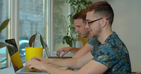 Two IT programmers are working on computer in a modern office room. Web Stockfoto's