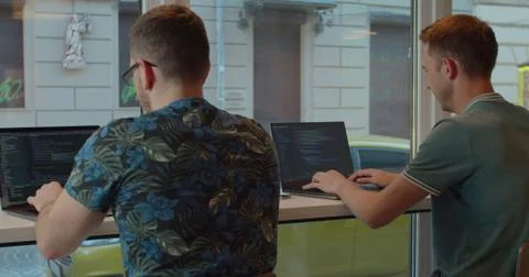 Two IT programmers are working on computer in a modern office room. Web 写真素材