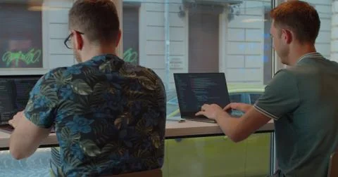 Two IT programmers are working on computer in a modern office room. Web Foto stock