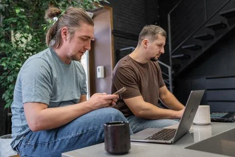 Two It Software engineers working on project and programming in coffee shop Stock-Fotos