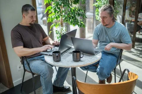 Two It Software engineers working on project and programming in coffee shop Stock-Fotos