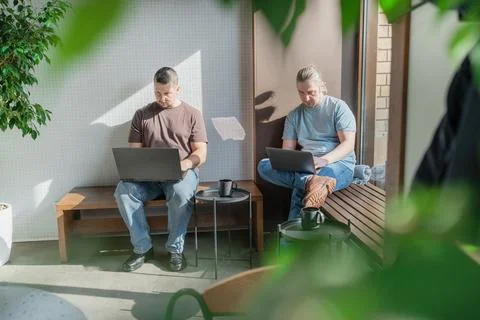Two It Software engineers working on project and programming in coffee shop Stock Photos