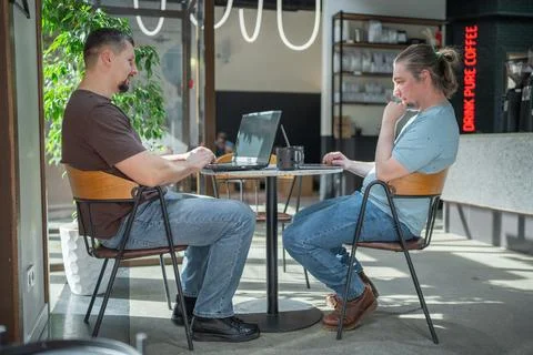 Two It Software engineers working on project and programming in coffee shop Stock-Fotos