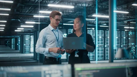 Two IT Specialists Working on Computer in Data Center Stock Footage 167231306