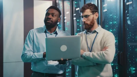 Two IT specialists working in cyber security server room at data center. Chief Stock Footage 119232041