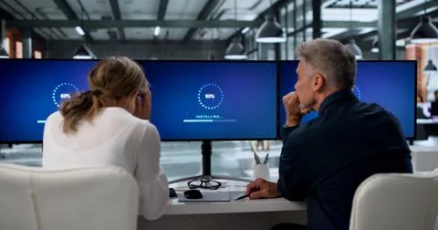 Two IT Specialists Working Together On Updating Slow Computer Systems. Stock Photos