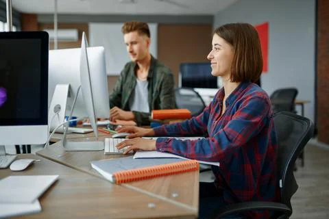 Two IT specialists works on computers in office Stock Photos