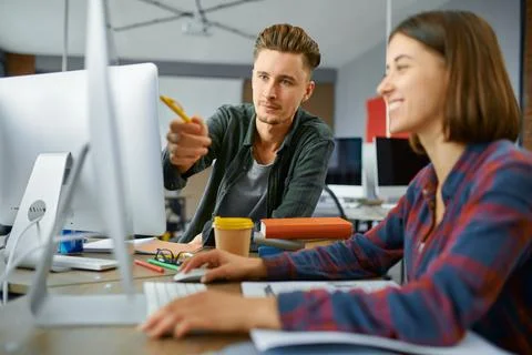 Two IT specialists works on computers in office Stock Photos