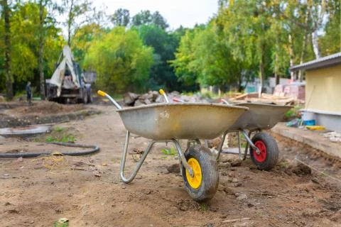 Two jack-lifts or two-wheeled construction trucks or hand-carts in construction Stock Photos