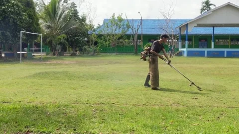 Two janitors are cutting grass in the yard. Stock Footage 306472838