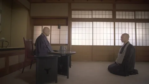 Two japanese buddhist monks conversing in a temple dojo Stock Footage 340563610