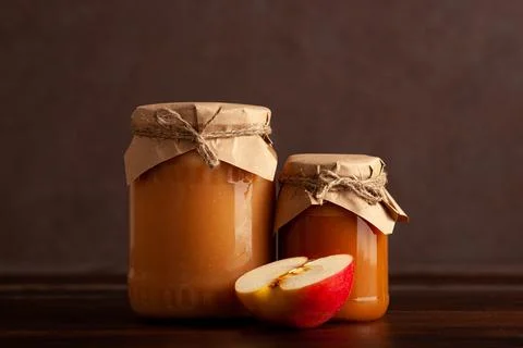 Two jars of apple jam with apple slice on wooden table Stock Photos