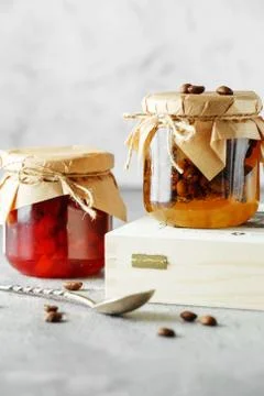 Two jars of fruit homemade jam. pear marmalade with coffee beans and Jar of b Stock Photos